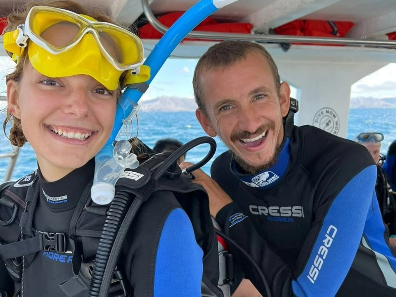 happy couple in scuba gear on honeymoon dive in costa rica